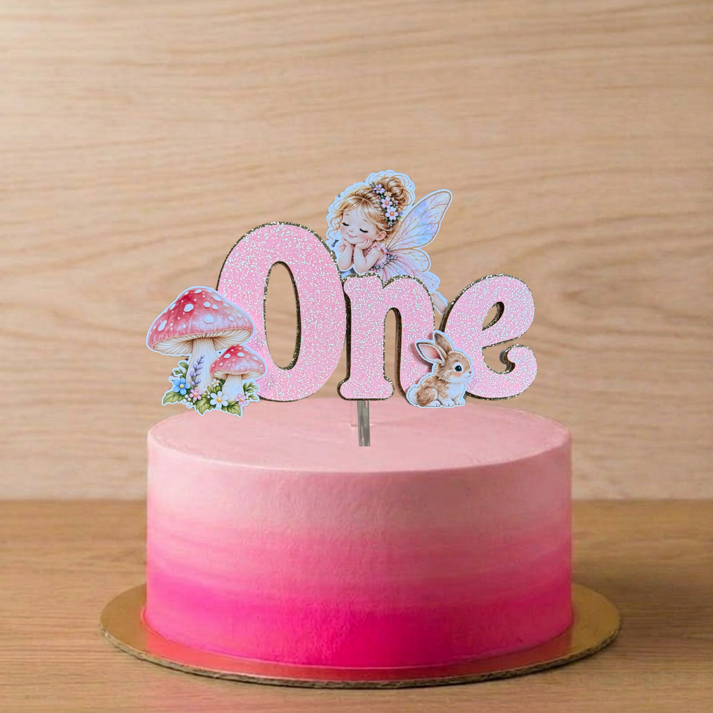 Pink glitter fairy first birthday cake topper displayed on a pink birthday cake