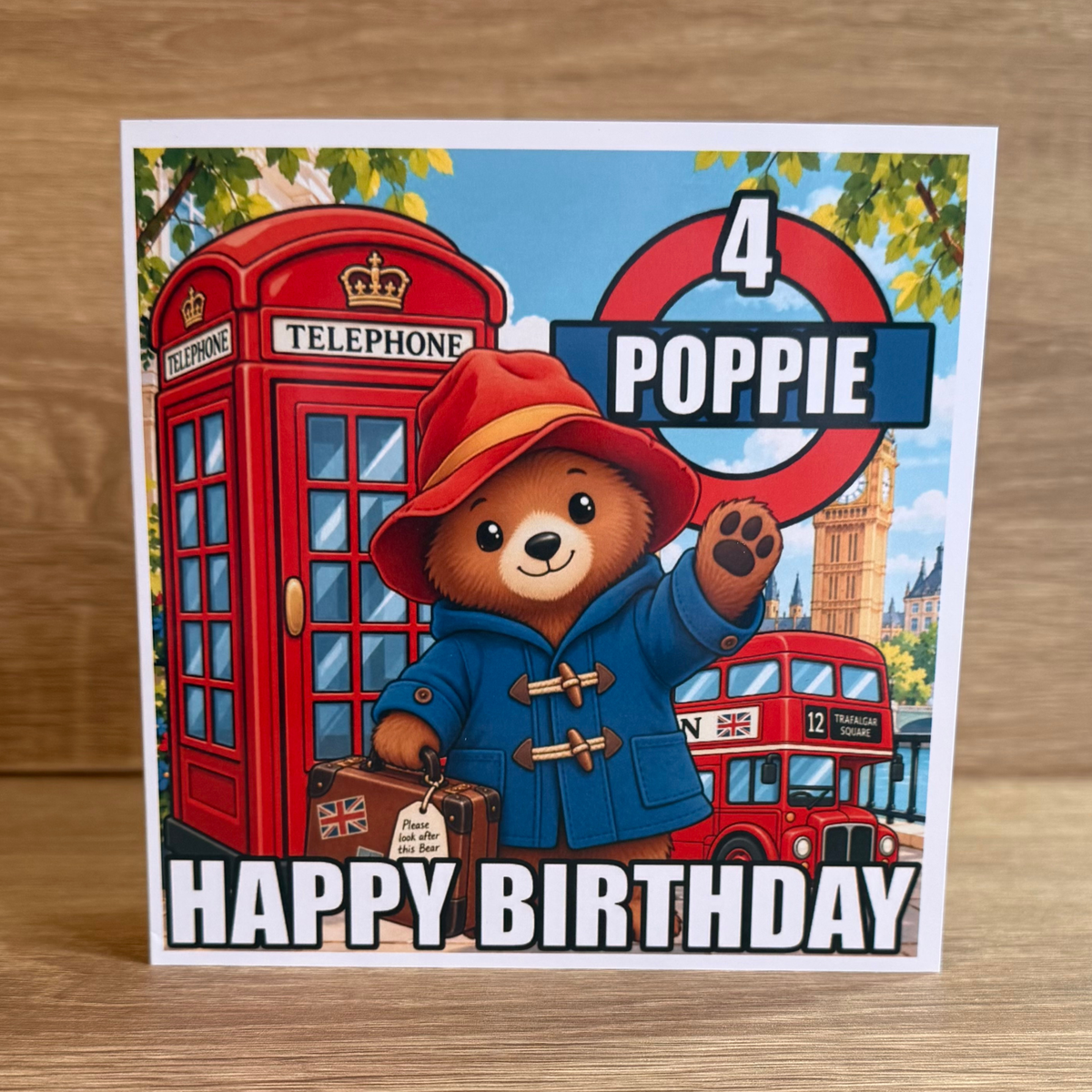 Paddington Bear personalised 6x6 birthday card with name Poppie age 4 and colourful London bus and telephone box design