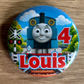Thomas the Tank Engine personalised 58mm birthday badge with name and age, railway crossing and blue train