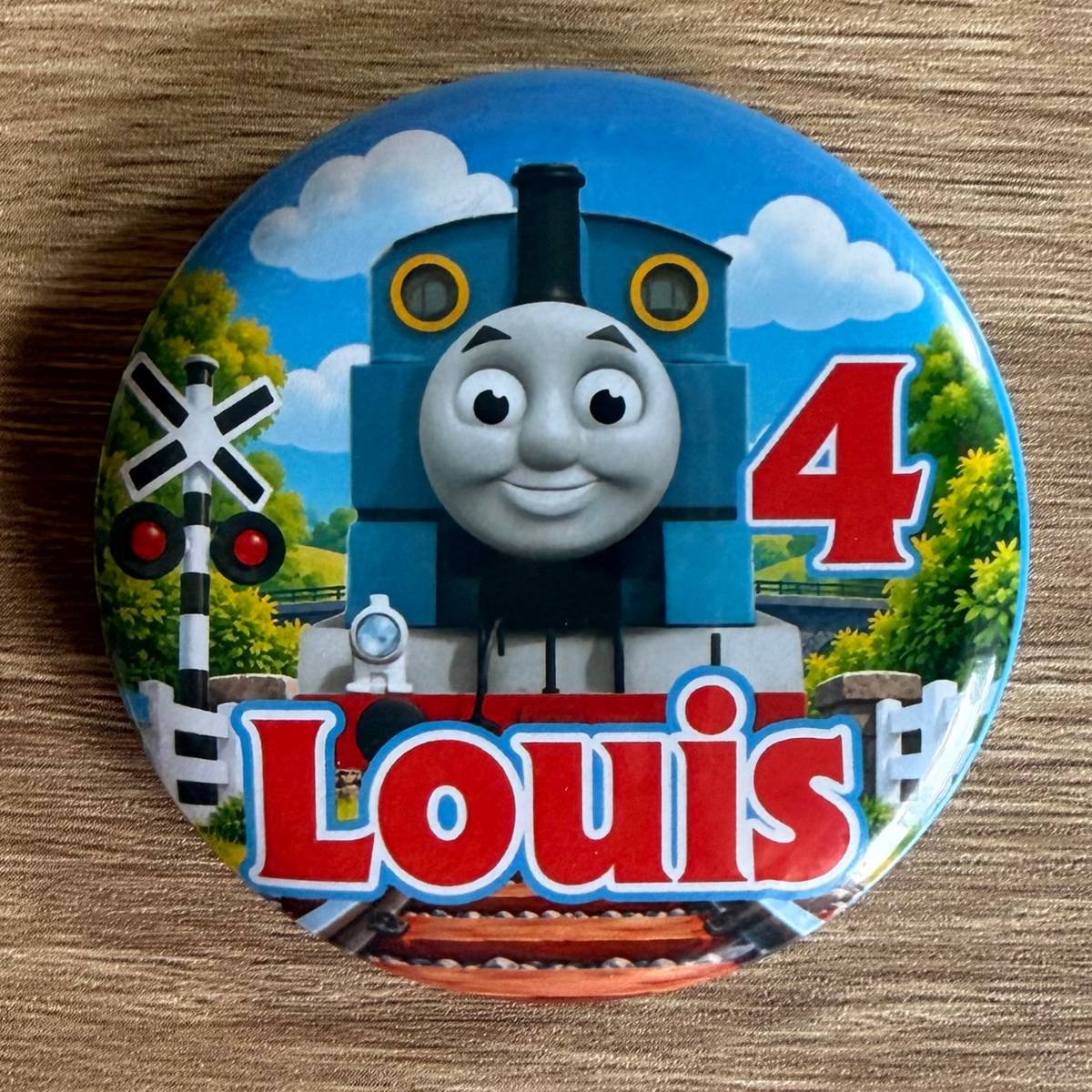 Thomas the Tank Engine personalised 58mm birthday badge with name and age, railway crossing and blue train