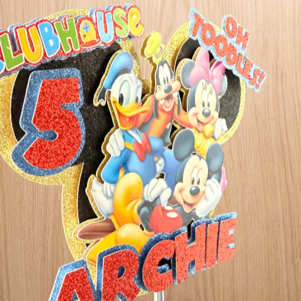 Side view of the personalised Mickey Mouse cake topper showing the layered glitter-card detail