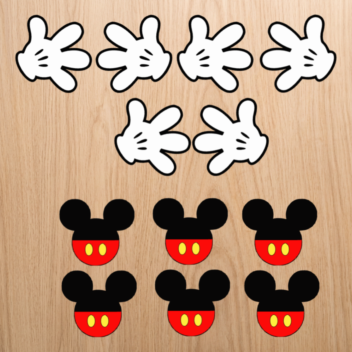 Set of 12 matching Mickey Mouse-inspired cupcake toppers with glove and shorts designs