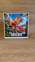 Paw Patrol Dino Movie personalised birthday card featuring Chase, Marshall, Skye, Rocky, orange T-Rex and volcano, Archie age 3